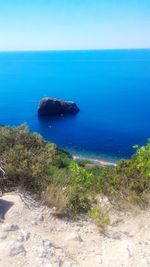 Scenic view of sea against clear blue sky