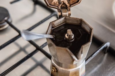 High angle view of coffee cup on metal