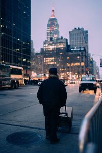 Rear view of man with cityscape in background