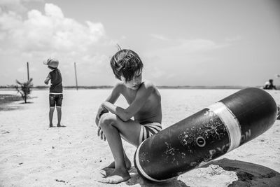 People at beach against sky