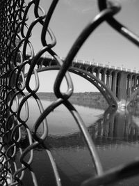 Close-up of chainlink fence against sky