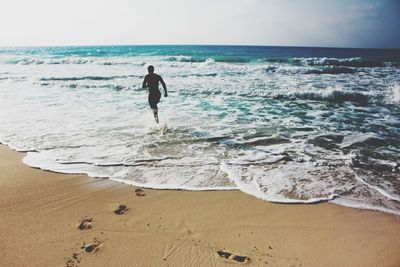 Full length of man on beach against sky