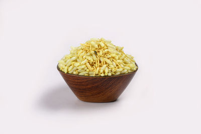 High angle view of bread in bowl on table against white background