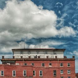 Low angle view of building against cloudy sky