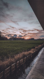 Scenic view of field against sky during sunset