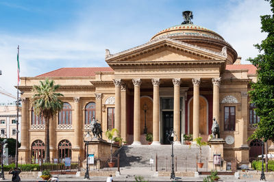 Facade of historic temple against sky