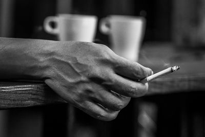 Close-up of man hand holding cigarette