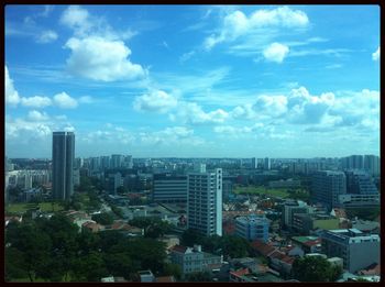 Skyscrapers against cloudy sky