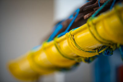 Close-up of yellow bell hanging on table