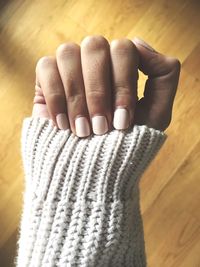 Cropped hand of woman showing painted fingernails