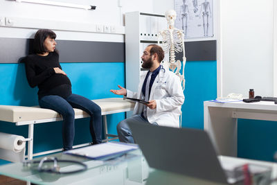 Midsection of female doctor working in laboratory