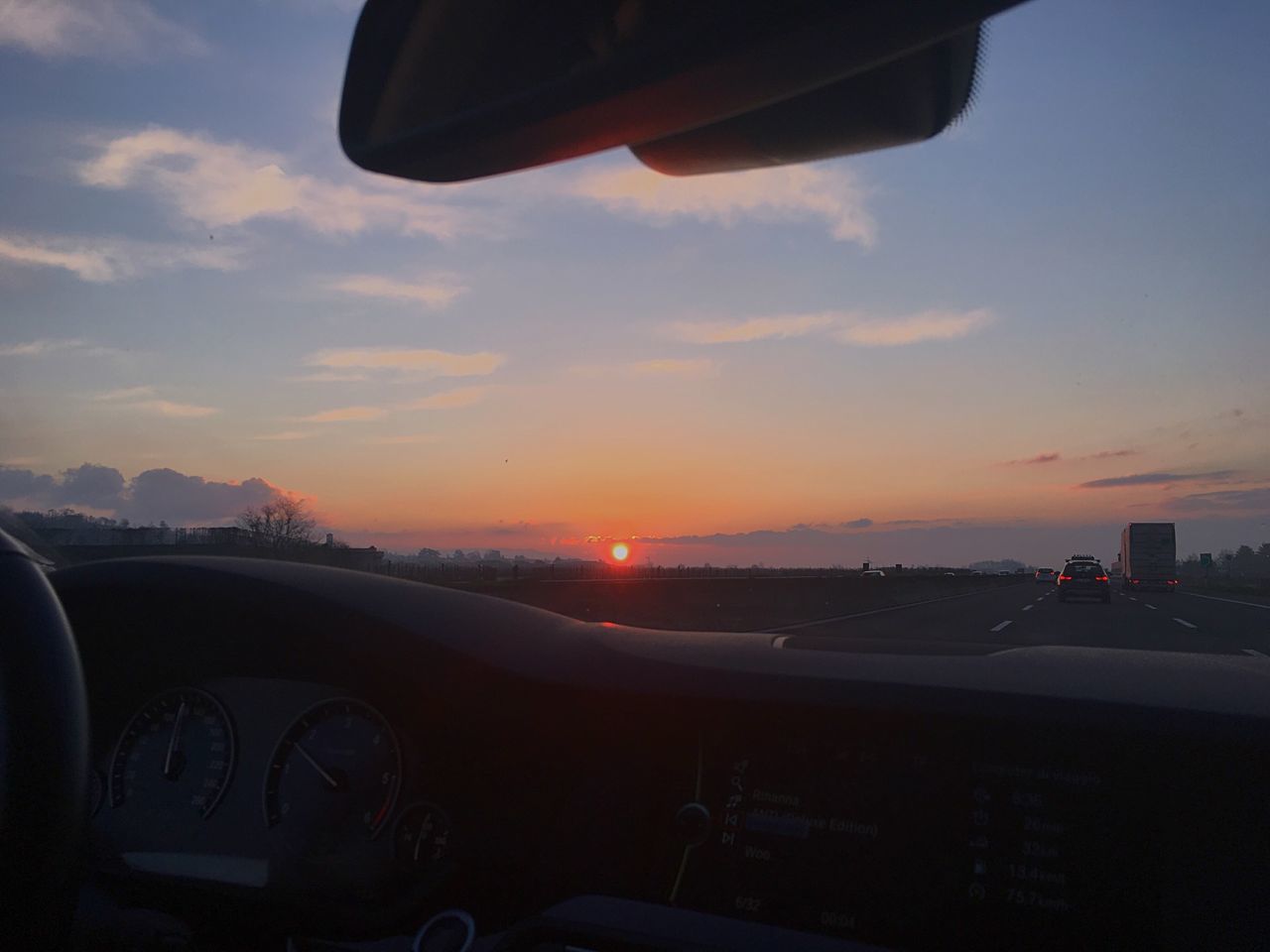 transportation, mode of transport, car, sunset, land vehicle, sky, vehicle interior, part of, travel, cropped, airplane, air vehicle, cloud - sky, on the move, journey, car interior, side-view mirror, road, orange color, glass - material