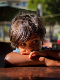 Close-up portrait of cute boy looking away