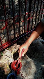 High angle view of human hand on rusty metal