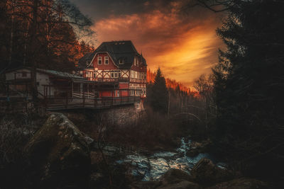 Abandoned building against sky during sunset