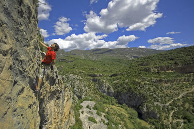 High angle view of man climbing rock