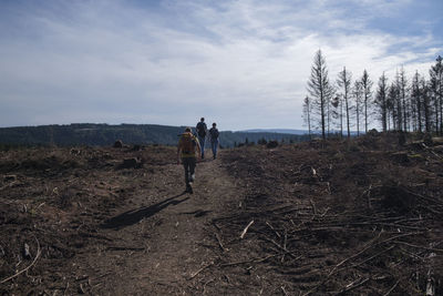 People walking on land against sky