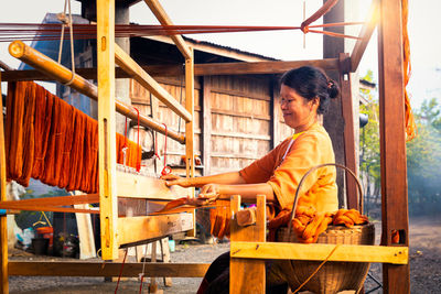 Side view of man working on table