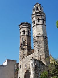 Low angle view of historical building against clear blue sky