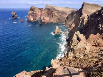 High angle view of rock formations by sea