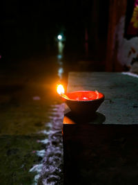 Close-up of illuminated lamp against black background