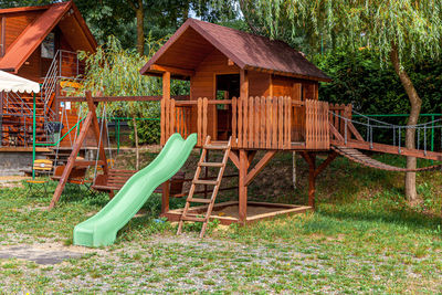 Grass growing in playground against house