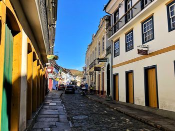 Narrow street amidst buildings against sky