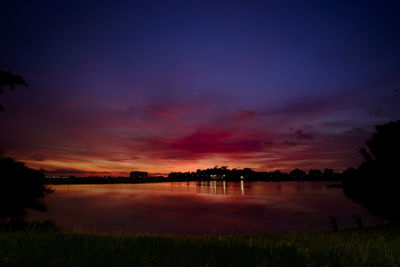 Scenic view of lake against romantic sky at sunset