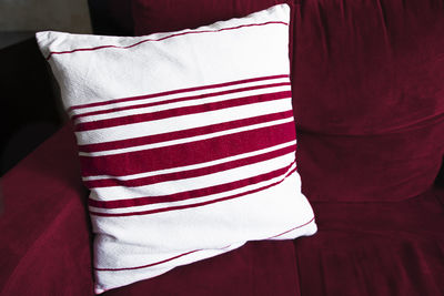 Home interior with viva magenta furniture in rich color of the year 2023 and decorative pillow.