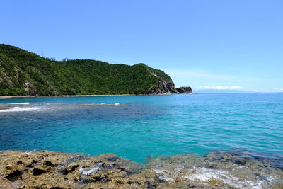 Scenic view of sea against clear blue sky