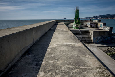View of building by sea against sky