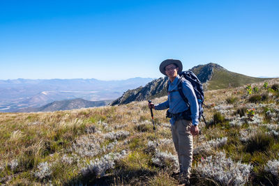 Man standing on mountain against clear sky