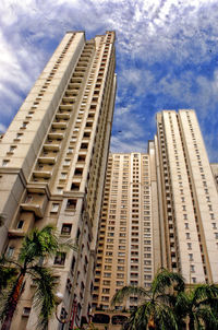 Low angle view of skyscraper against cloudy sky