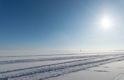 Scenic view of snow covered land against clear sky