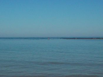 Scenic view of sea against blue sky