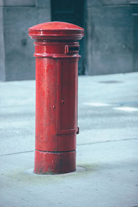 Close-up of red fire hydrant on sidewalk