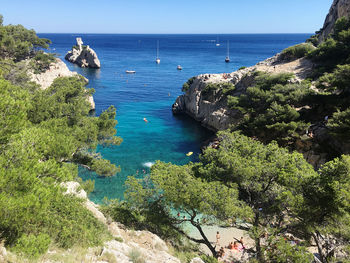 High angle view of sea and trees against sky