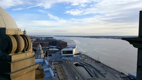 Panoramic view of city against cloudy sky