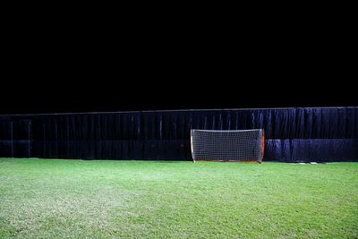 Soccer field against sky at night