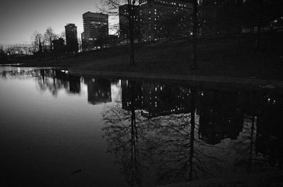 Reflection of illuminated buildings in city at night