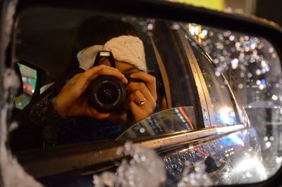 Close-up of woman clicking photo in car