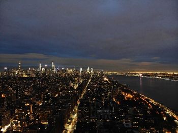 High angle view of illuminated buildings against sky at night