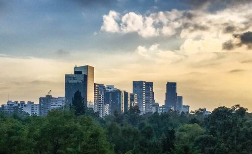 Buildings against cloudy sky