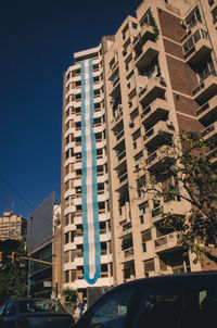 Low angle view of modern buildings against clear blue sky