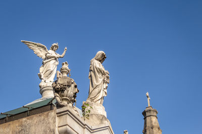 Low angle view of statue against clear blue sky