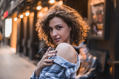 Portrait of young woman holding smart phone