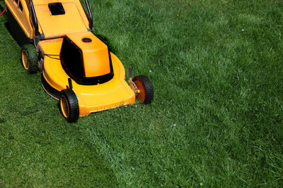 High angle view of lawn mower on grassy field