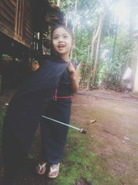 Portrait of smiling woman standing on land