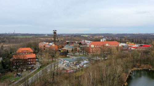 High angle view of buildings and trees against sky