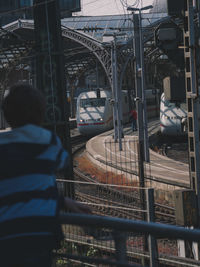 Rear view of man standing on railroad station